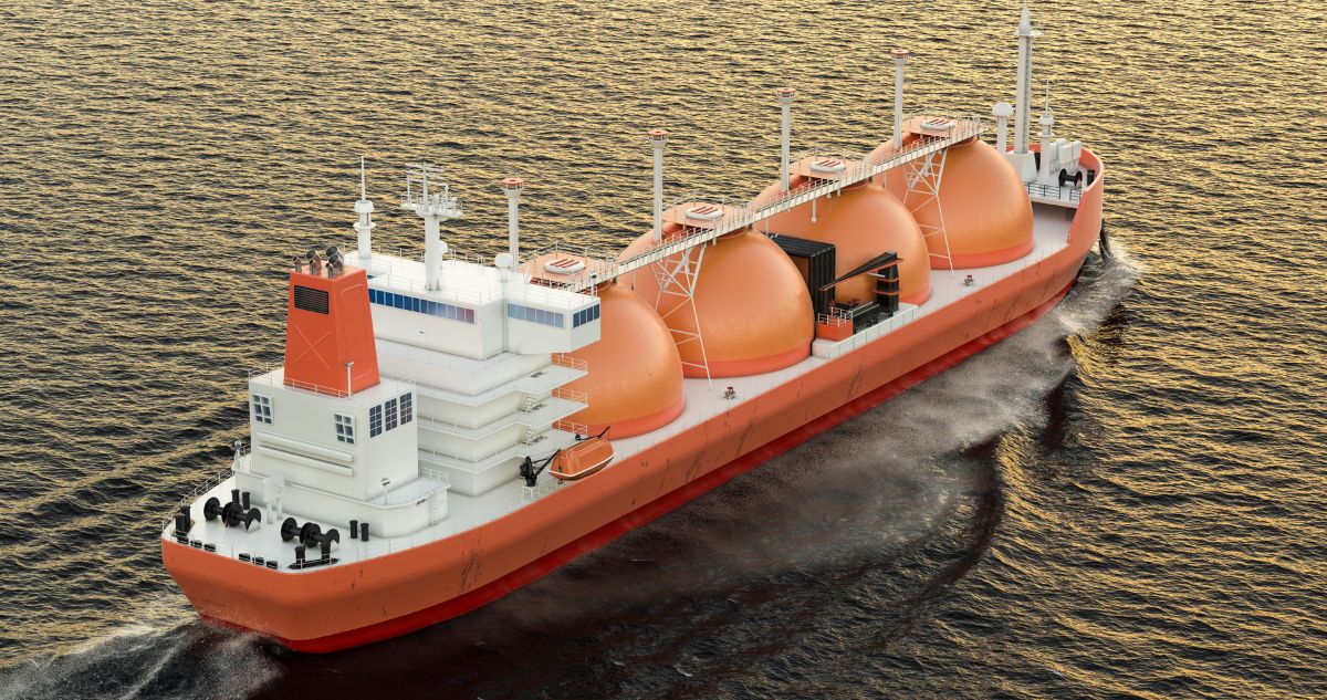 Ship vessel cruising at sea with four dome-like container containing liquefied natural gas